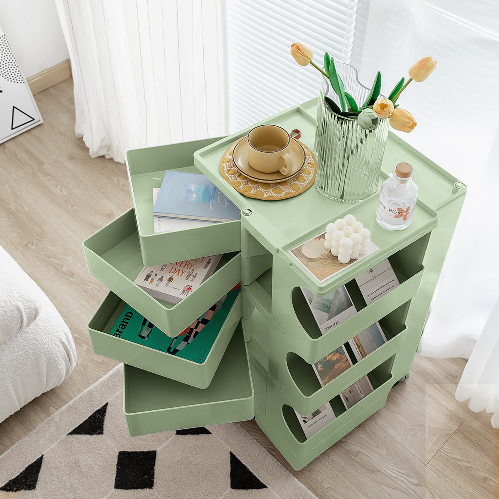 5 Tier Bedside Table Organizer Green with rotating trays, holding books, decor, and a vase with flowers in bedroom setting
