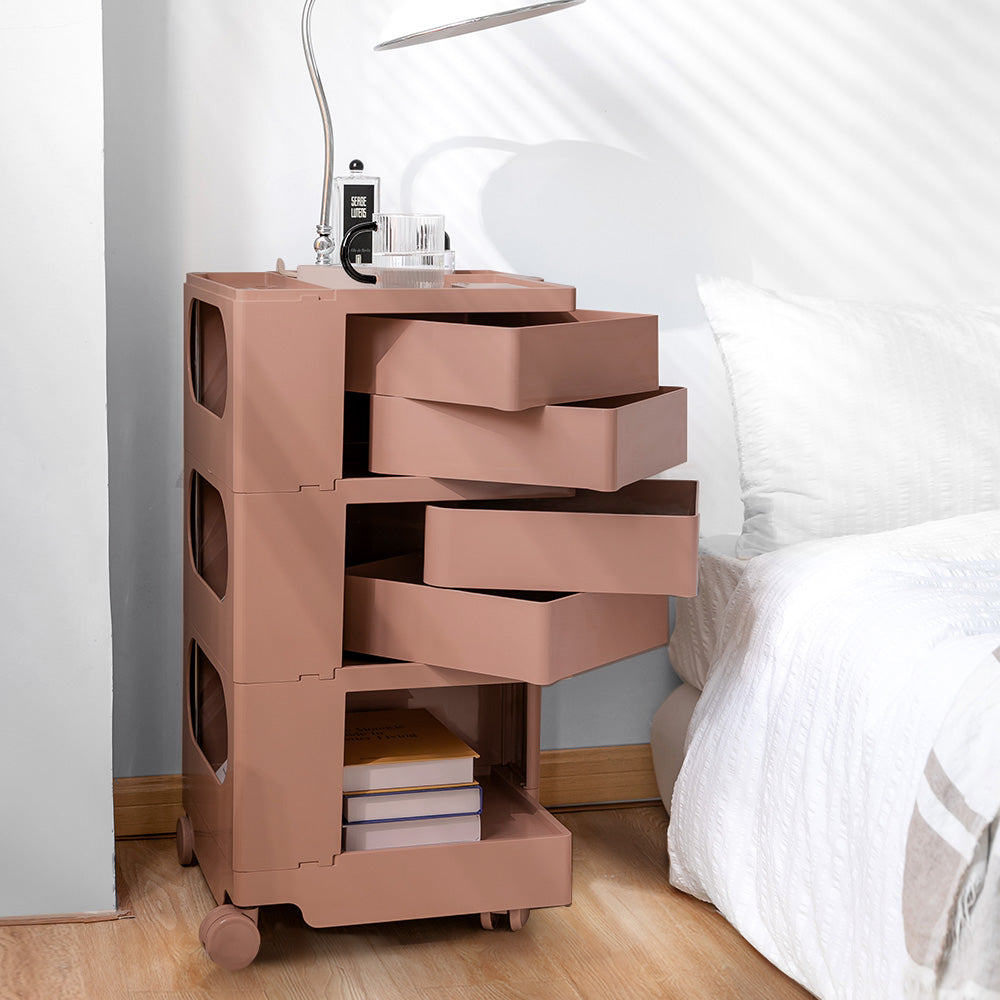 5 Tier Bedside Table Organizer Pink with open drawers, metal frame, storage space, placed beside bed in bedroom setting