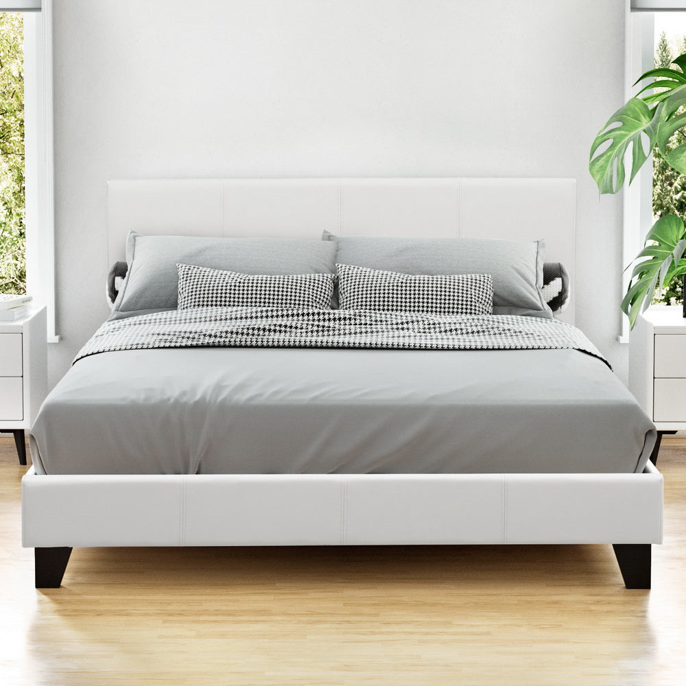 Coogee Queen Bed Frame White with padded headboard, clean lines, black legs, and modern bedding in bright bedroom setting
