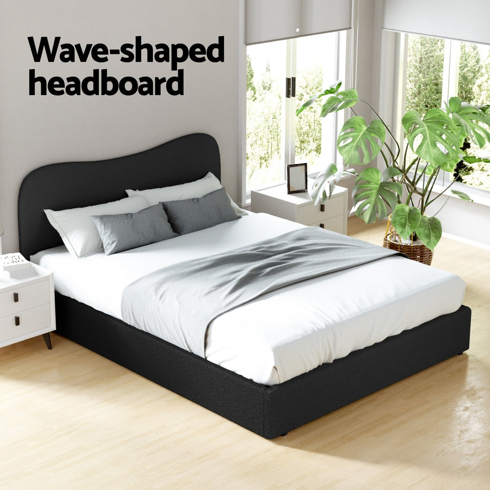 Albany Bouclé Queen Bed Frame - Black with wave-shaped headboard in a bright bedroom setting with plants and bedside table
