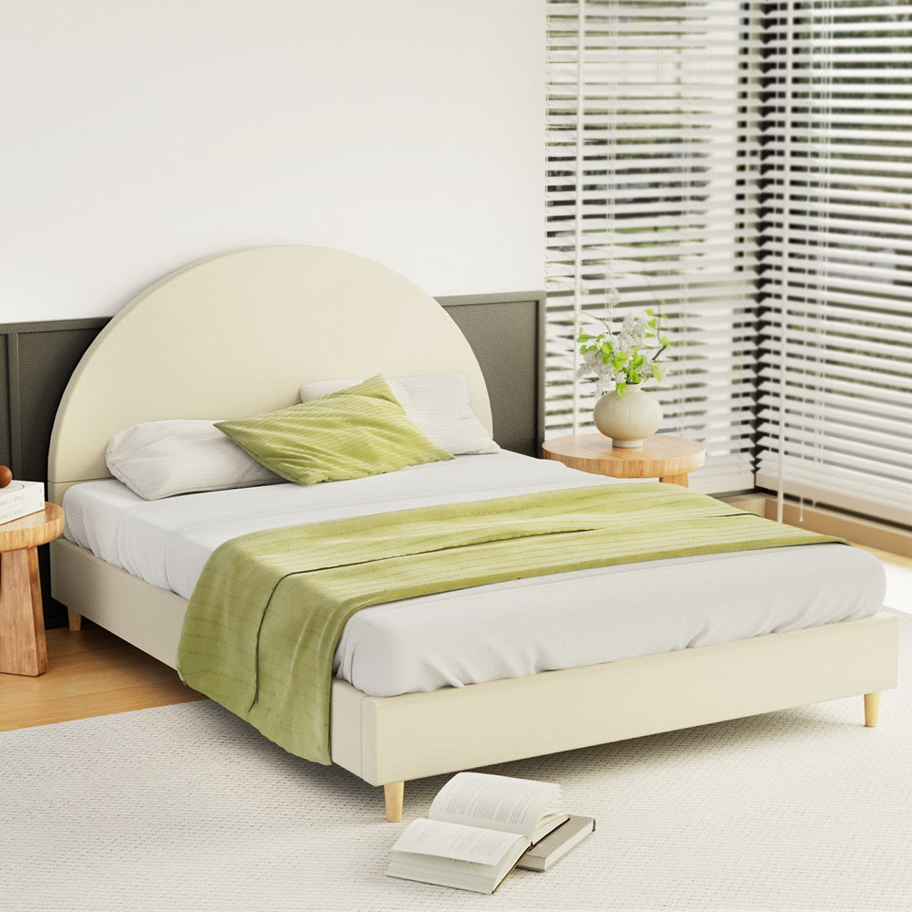 Ella Arched Queen Bed Frame Cream Velvet with curved headboard, wooden legs, and light bedding in a bright bedroom setting