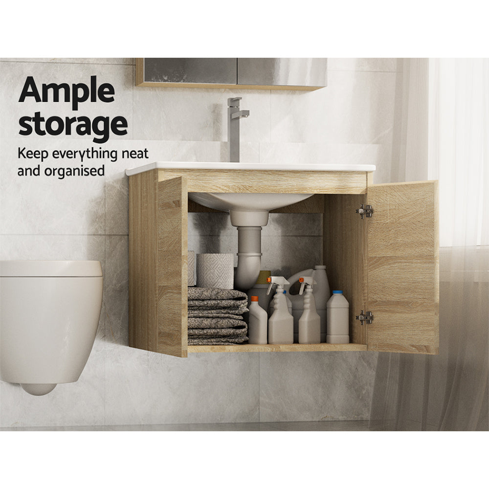 Vanity Unit 600mm with Basin Oak featuring open double doors, ample storage space with towels and cleaning bottles inside.