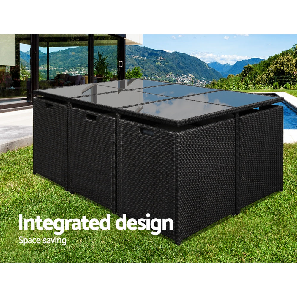 Outdoor Dining Set 11 Piece Wicker Table Chairs Setting Black with space-saving integrated design on green lawn