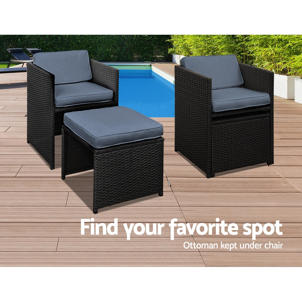 Outdoor Dining Set 11 Piece Wicker Table Chairs Setting Black with cushioned chairs and ottoman by pool on wooden deck