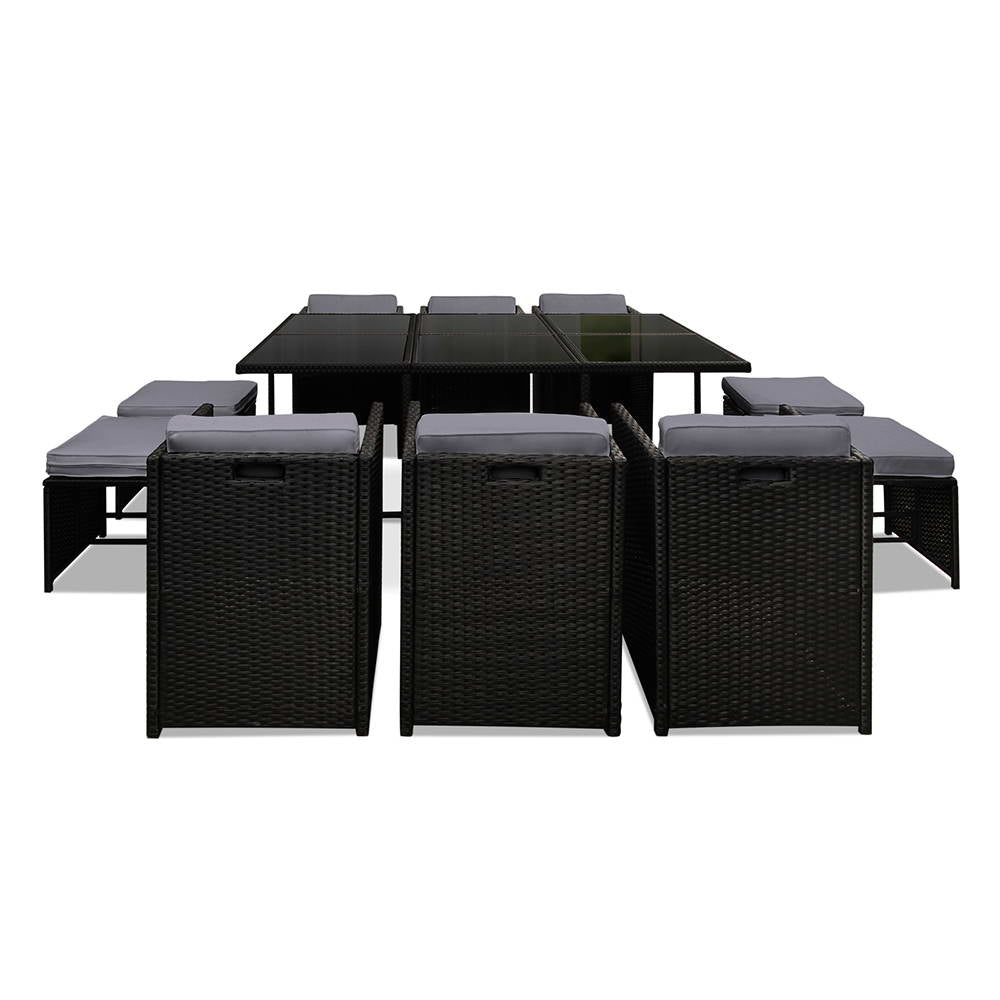 Outdoor Dining Set 11 Piece Wicker Table Chairs Setting Black with glass top table and cushioned wicker chairs on white background