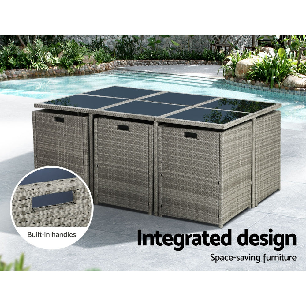 Outdoor Dining Set 11 Piece Wicker Table Chairs Setting Grey with built-in handles and glass tabletop by the poolside