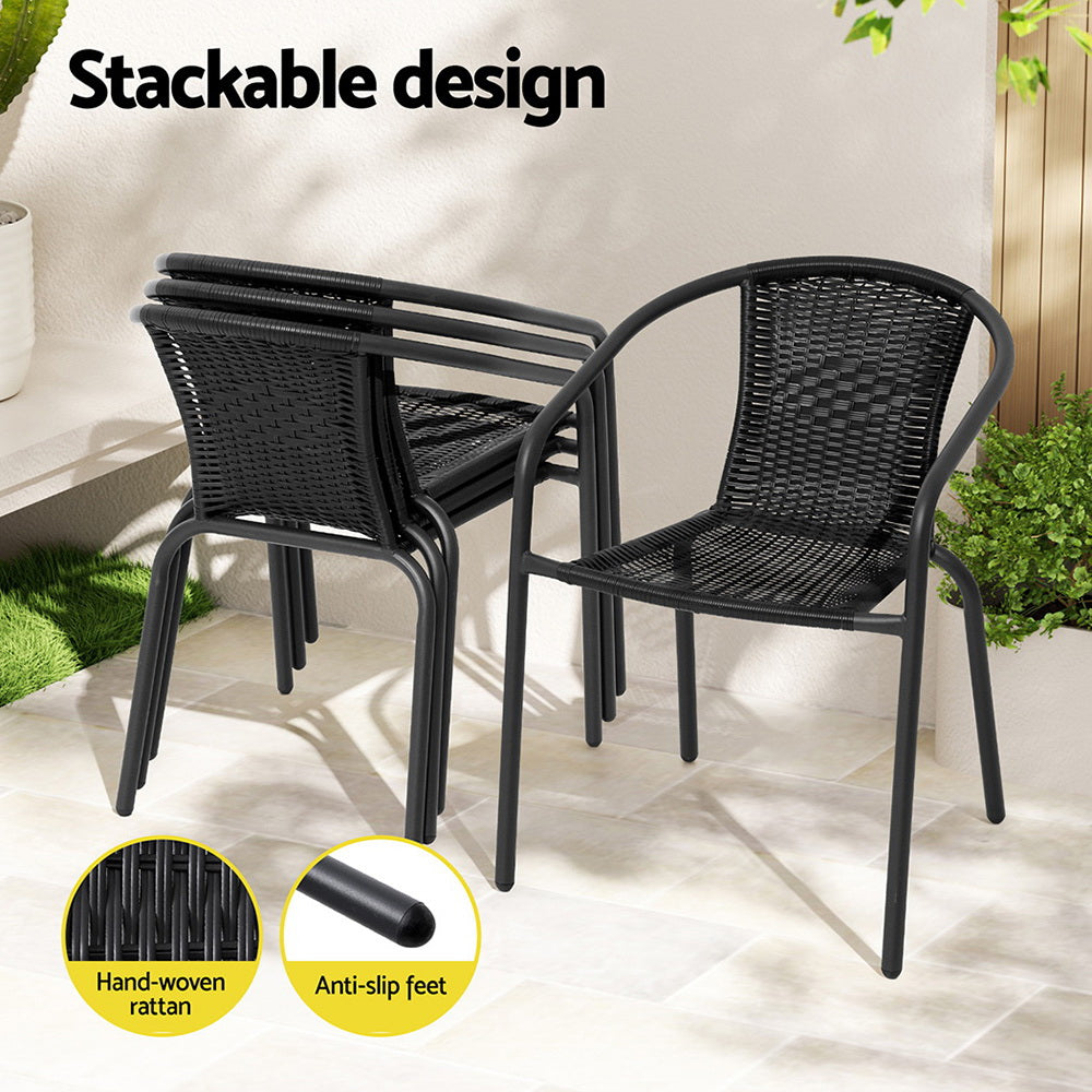 5 Piece Outdoor Dining Set with Stackable Chairs - Black showing black hand-woven rattan chairs with anti-slip feet stacked outdoors
