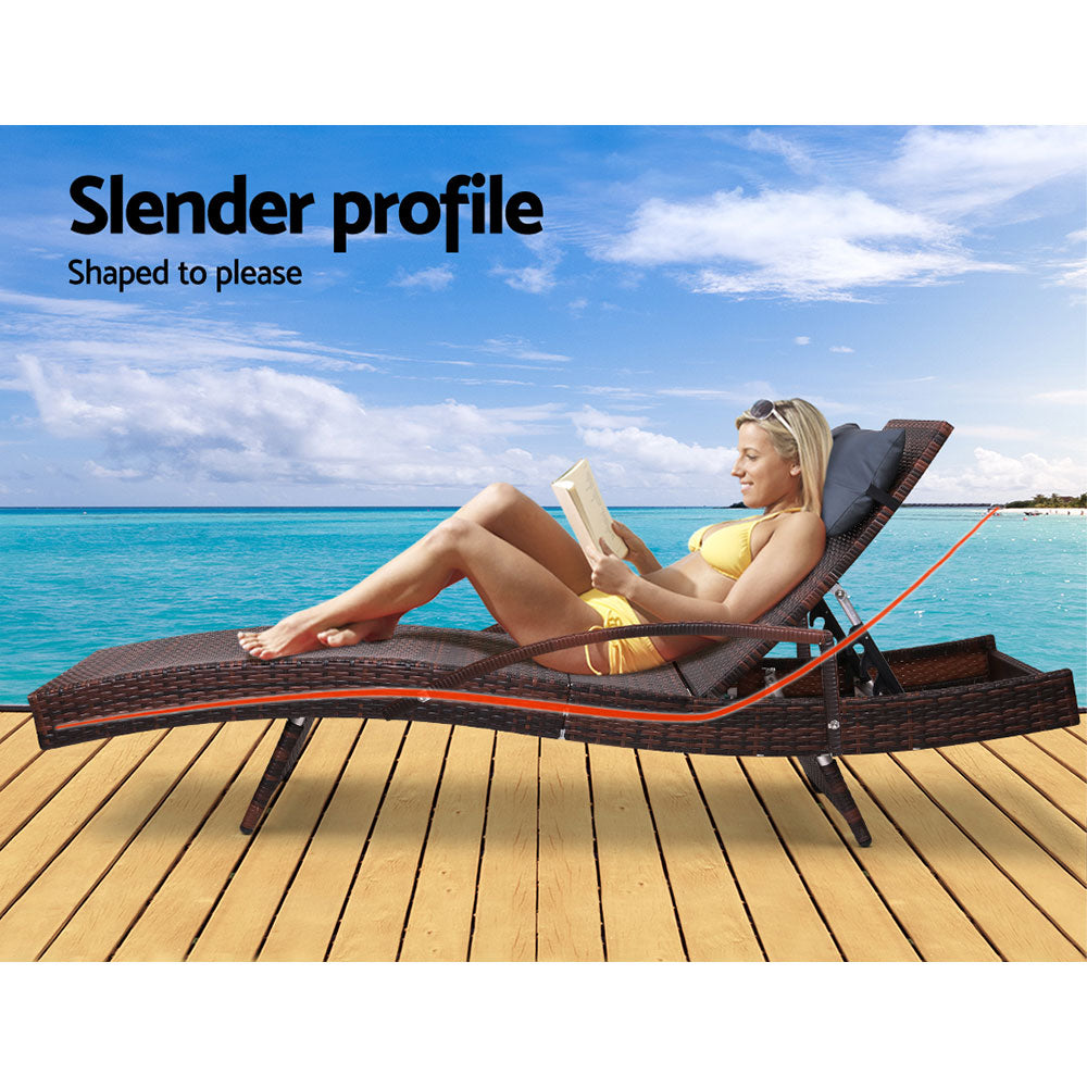 Set of 2 Bianca Outdoor Sun Lounger Chairs with Pillow Headrests - Brown, slender PE wicker design on wooden deck by water.