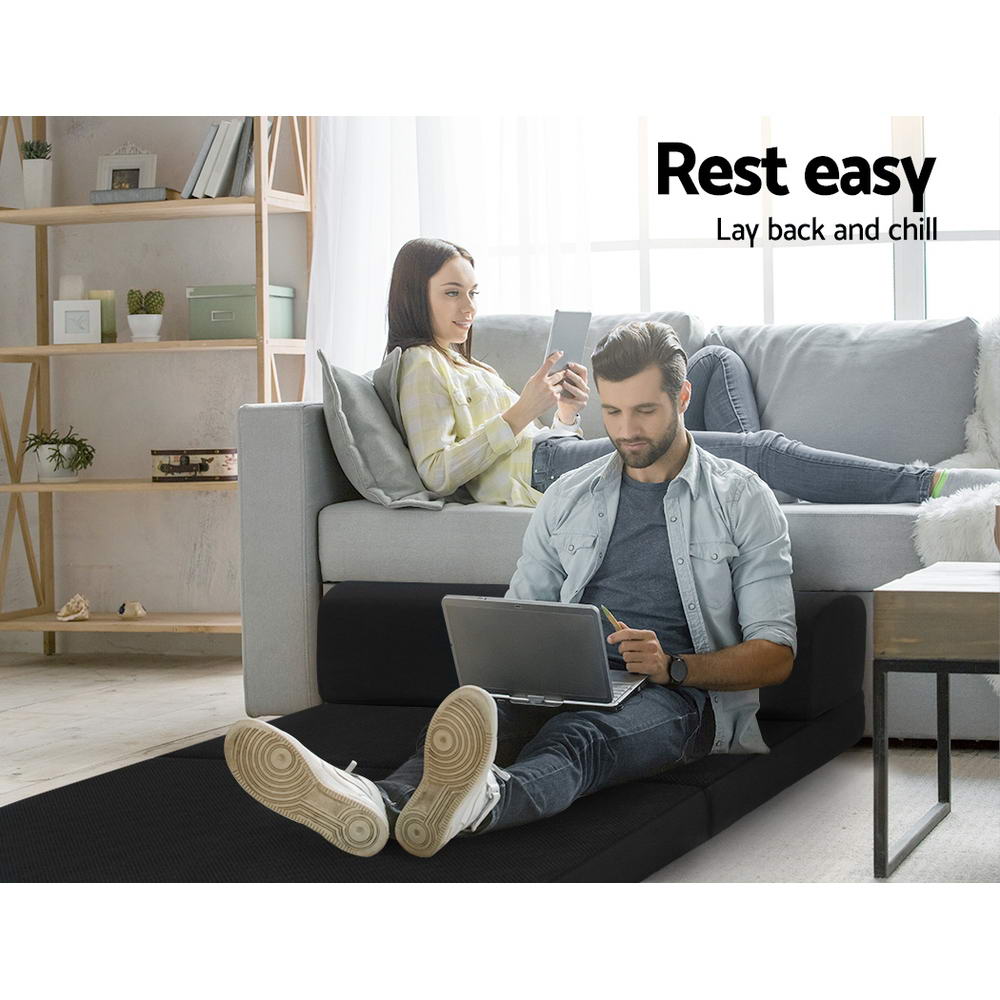 Folding Foam Mattress Portable Double Sofa Bed Mat Air Mesh Fabric Black shown as floor seating with two people relaxing in living room