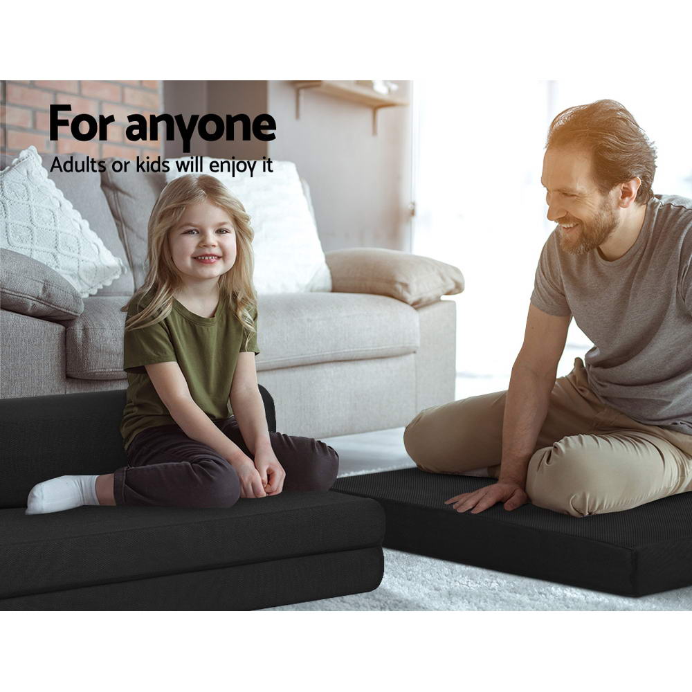Folding Foam Mattress Portable Double Sofa Bed Mat Air Mesh Fabric Black shown with child and adult sitting on folded mattress in living room