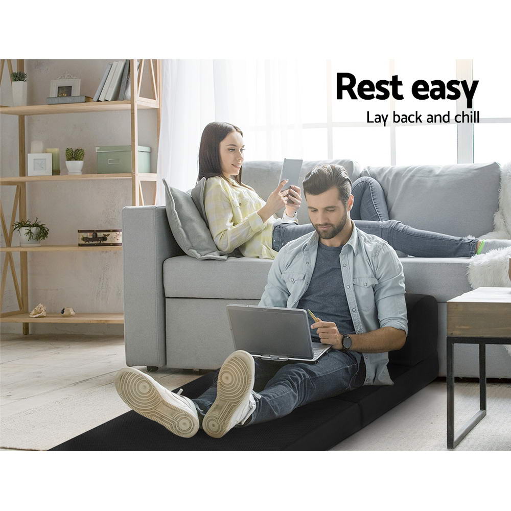 Folding Foam Mattress Portable Single Sofa Bed Mat Air Mesh Fabric Black used as floor sofa with man and woman relaxing in living room