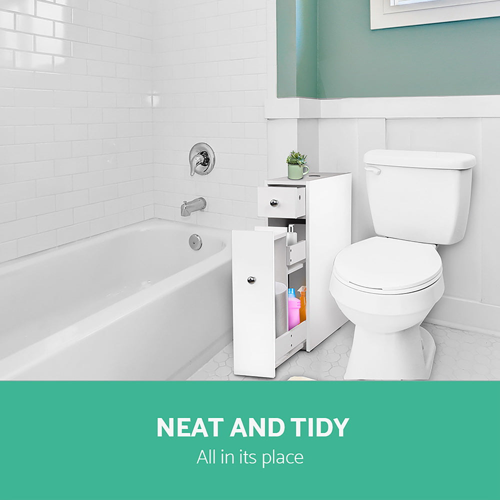 Bathroom Storage Cabinet Tissue Holder in white with open drawer and door, placed between bathtub and toilet in bright bathroom