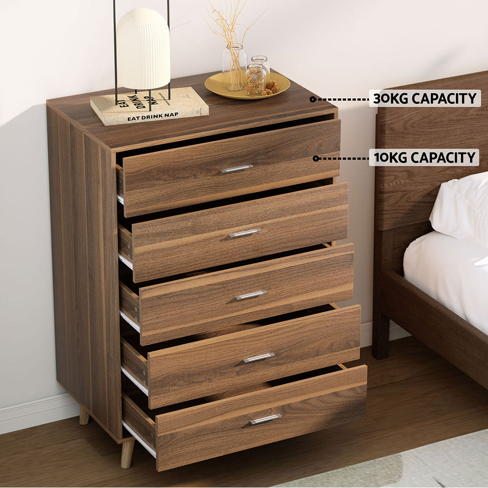 5 Chest of Drawers - MIRI Walnut with five spacious drawers and modern metal handles in a bedroom setting