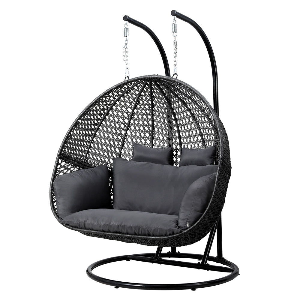 Outdoor Swing Chair Hanging Rattan Patio Furniture Pod Stand Cushion 2 Seater in black with cushions and metal frame on white background