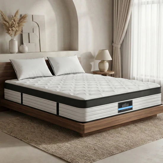 Serenity mattress on a wooden bed frame in a bedroom setting with decor elements.