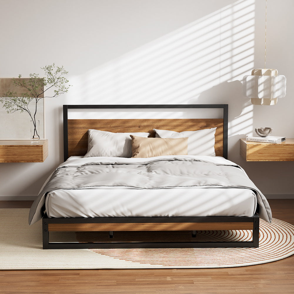 Stockton Metal Queen Bed Frame with black steel frame and wood panel headboard styled in a modern bedroom setting