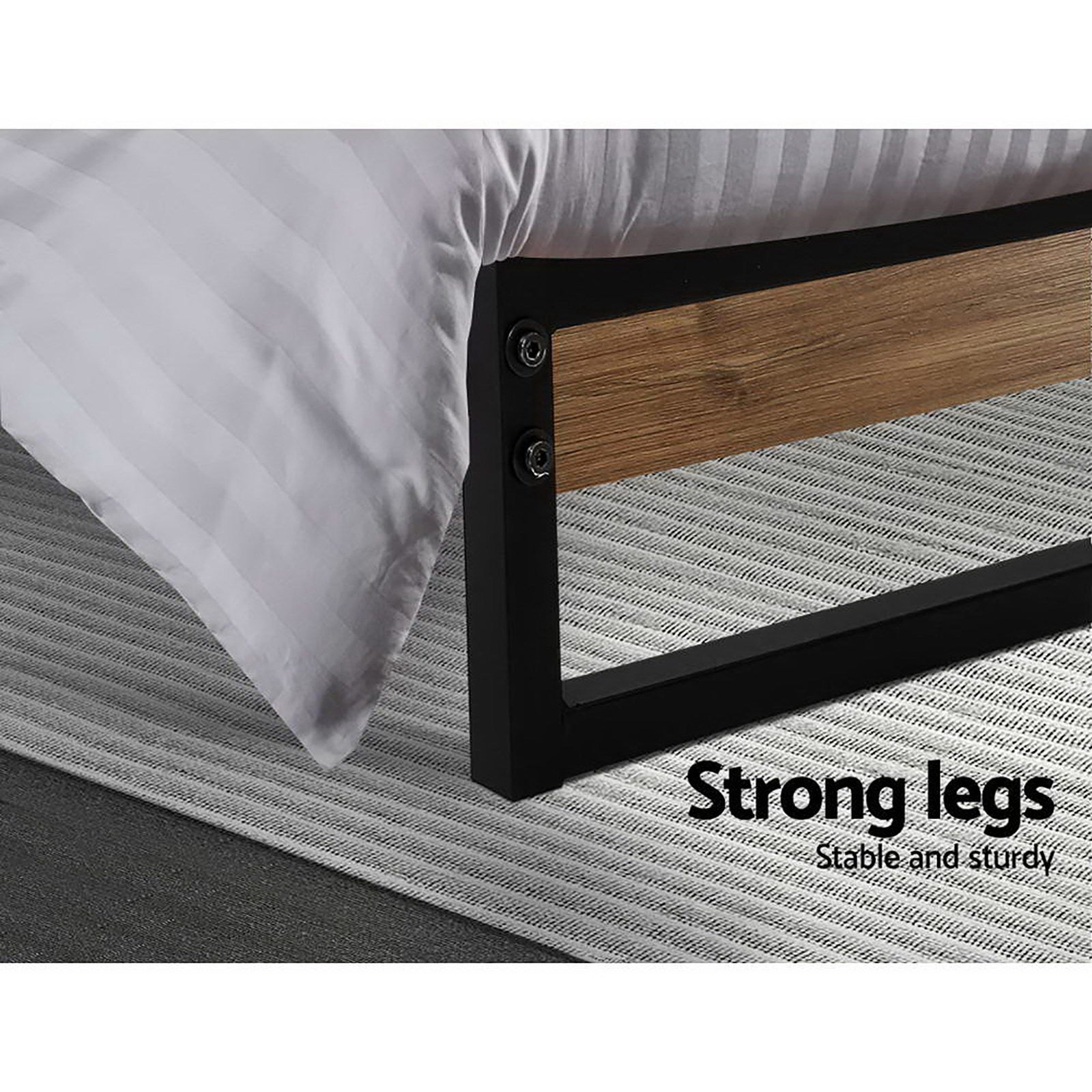 Close-up of black metal and wood leg on Stockton Metal Queen Bed Frame showing sturdy construction on gray rug