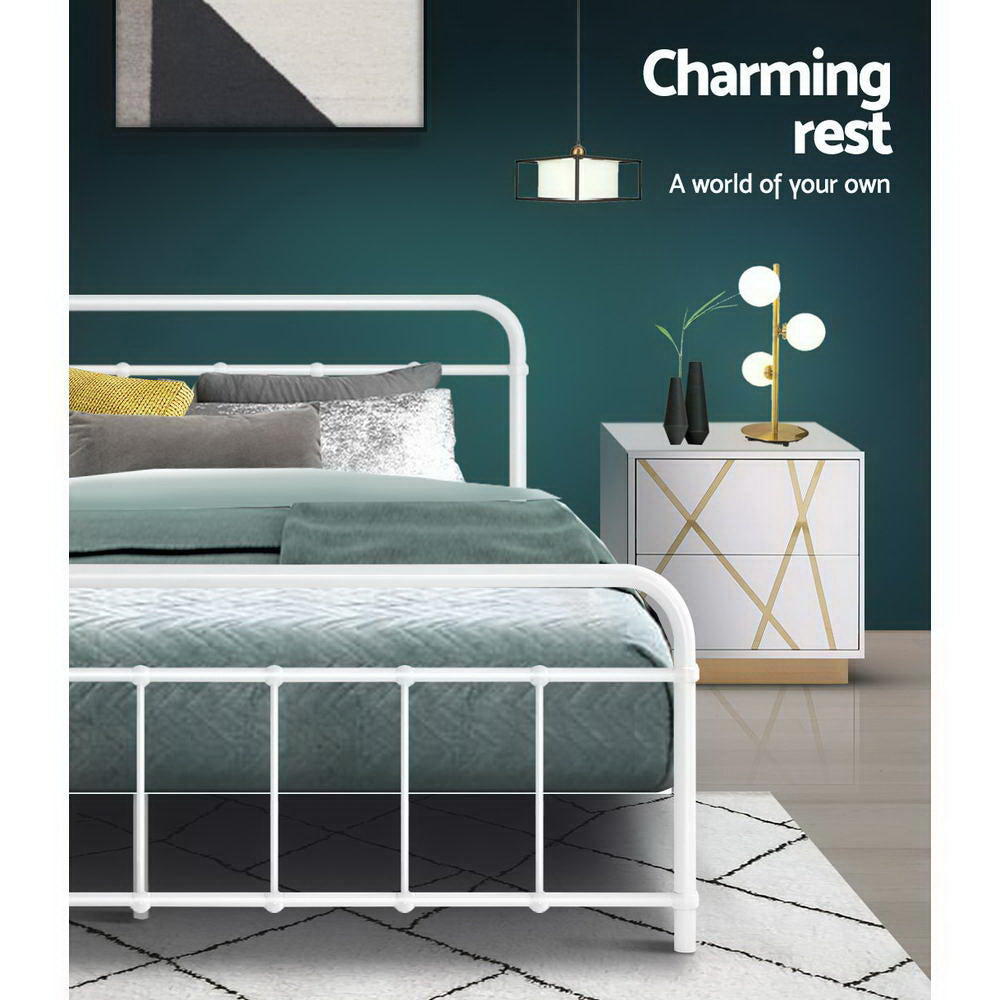 Leo Metal Queen Bed Frame White with sleek white steel construction, bedroom setup featuring bedside table and decorative lighting