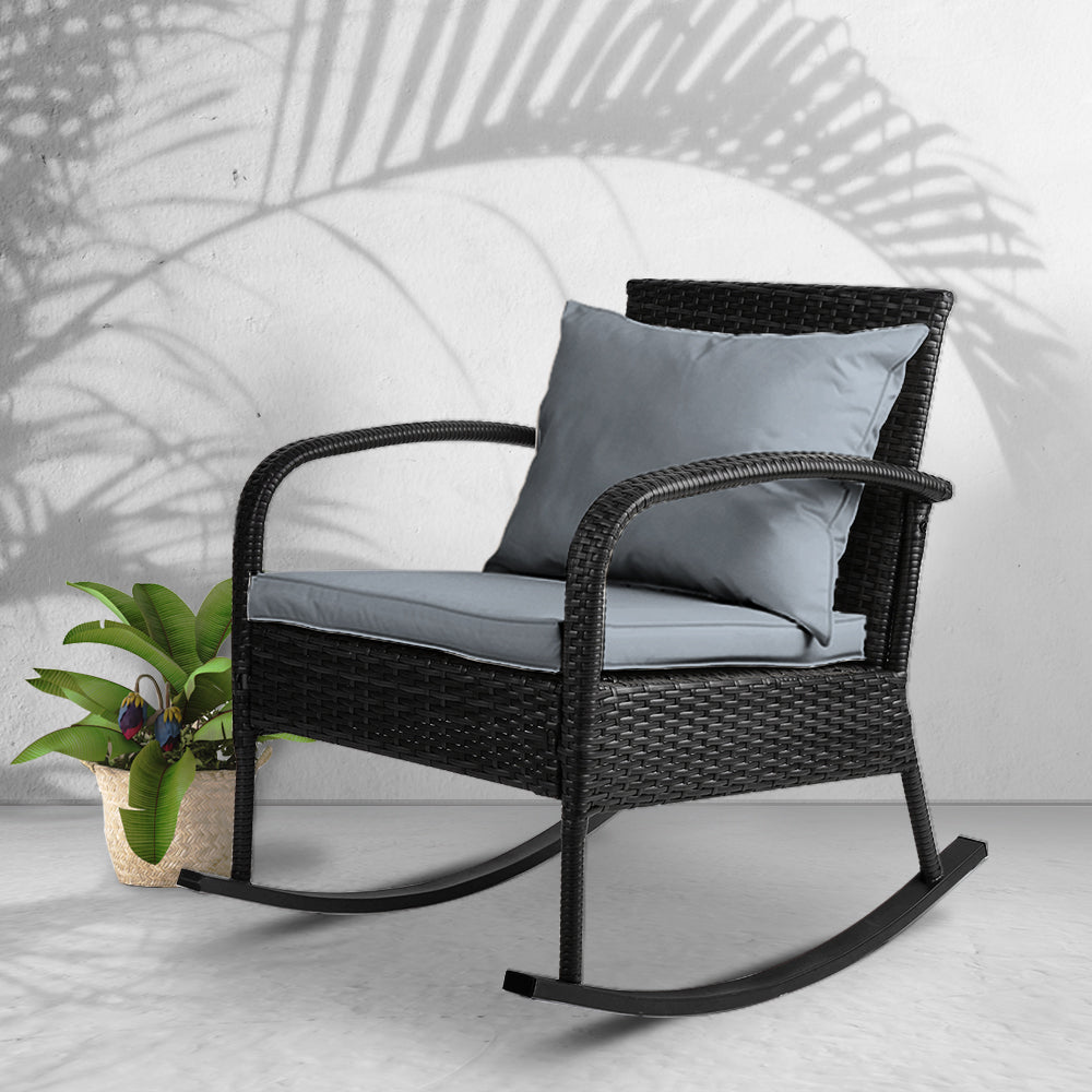 Outdoor Furniture Rocking Chair Wicker Garden Patio Lounge Setting Black with gray cushions and decorative plant on light background