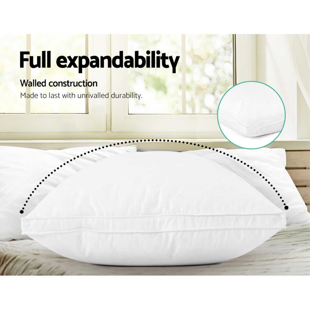 Feather Down Twin Pack Pillow shown with full expandability and walled construction on a bedroom bed setting