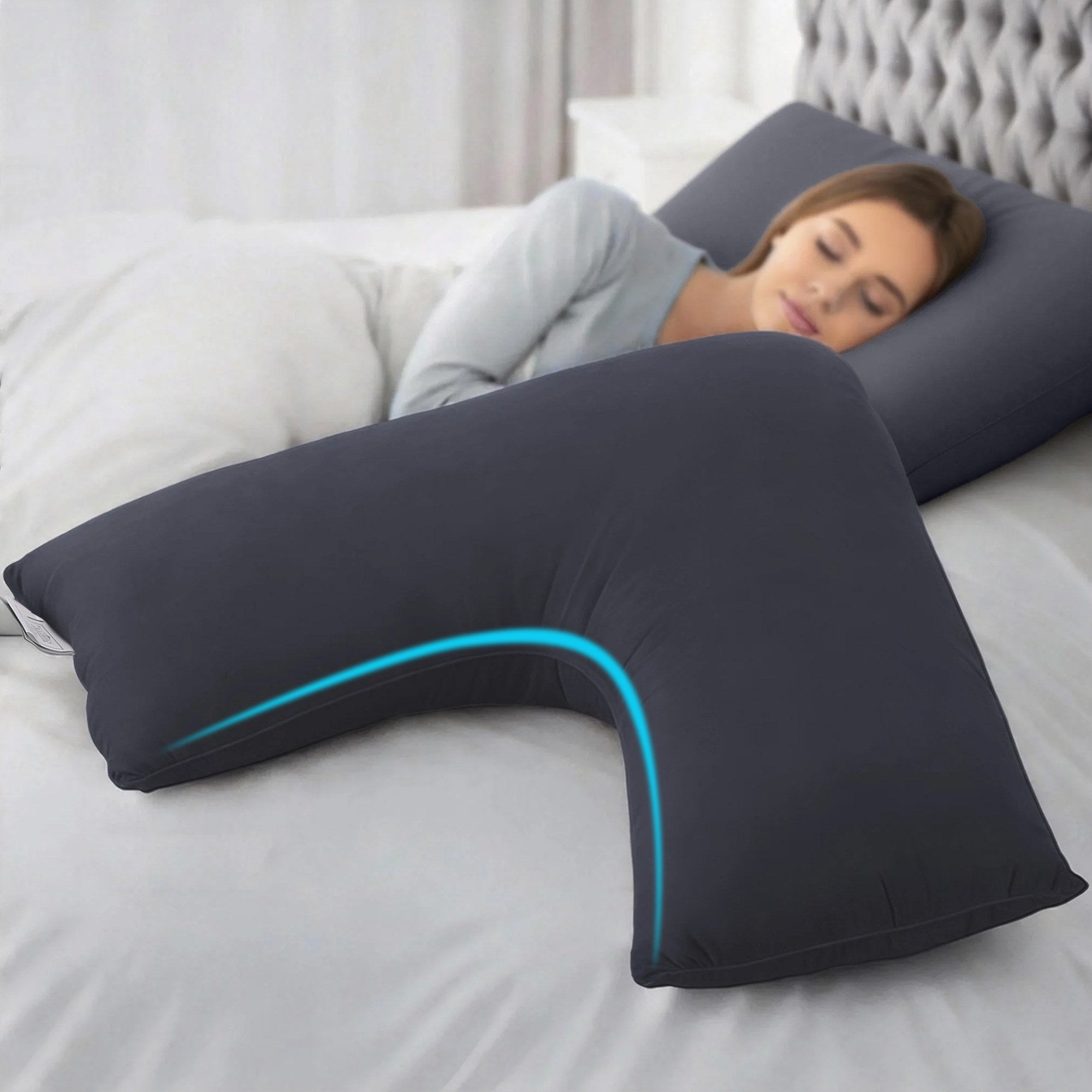 V Shape Pillow Boomerang Nursing Body Cushion Grey supporting a woman resting on a bed in a bedroom setting