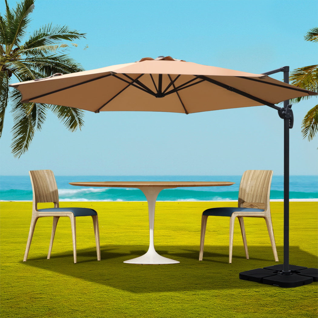3m Outdoor Umbrella w/Base Cantilever Beach Roma 360 Degree Tilt Beige with black frame shading outdoor table and chairs on lawn