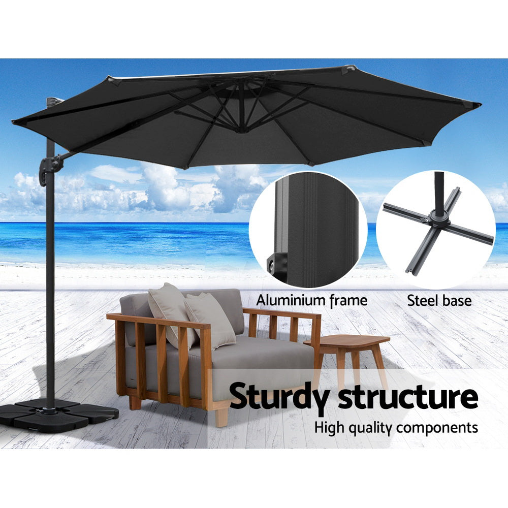 3m Outdoor Umbrella w/Base Cantilever Beach Roma 360 Degree Tilt Black with sturdy aluminum frame and steel base on a beach setting