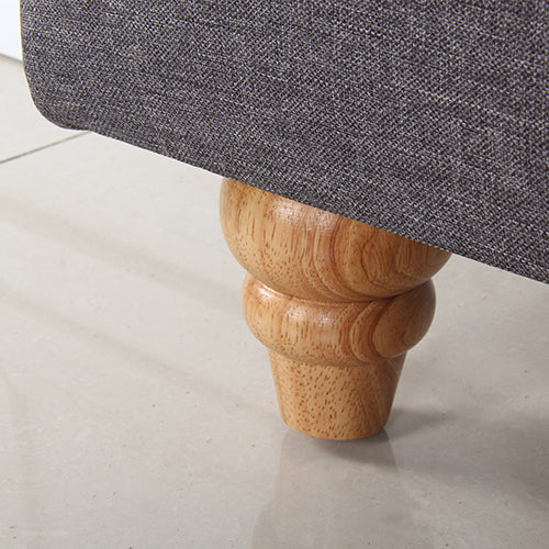 Close-up of wooden turned leg on gray fabric King Size | Sean Head Board from Bedzy bedroom furniture collection