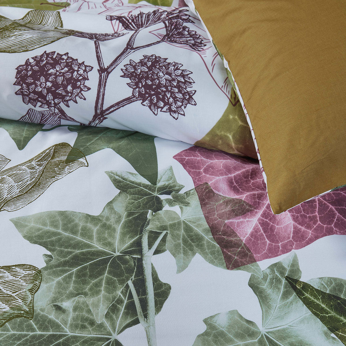 Bedding House Ivy Multi Cotton Quilt Cover Set Queen with layered ivy leaf print on light background and brown pillowcase