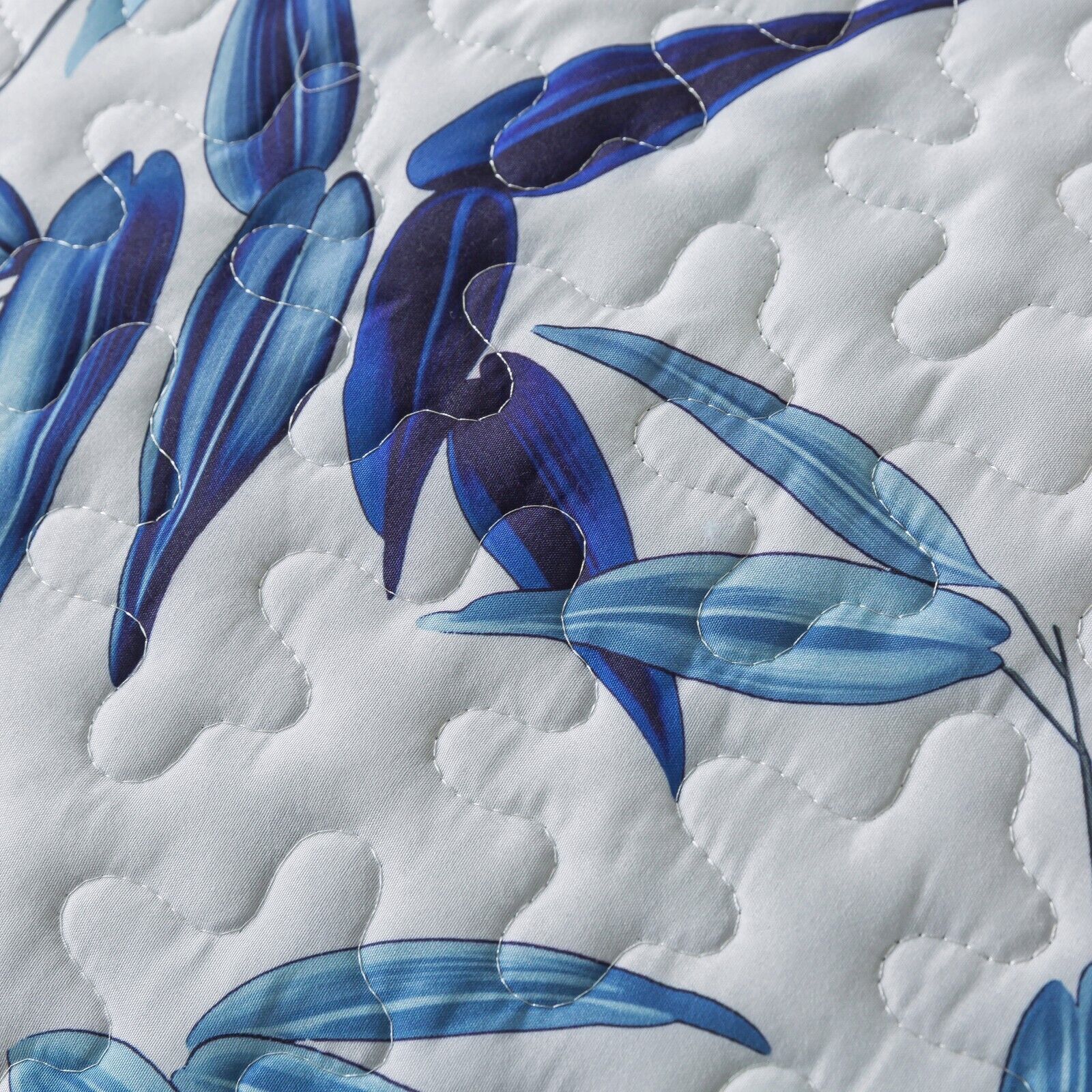 Close-up of white fabric with blue leaf print and quilted stitching from Ornate Vintage Lace purple blue3 Pc Bedspread & Pillow Cover Set