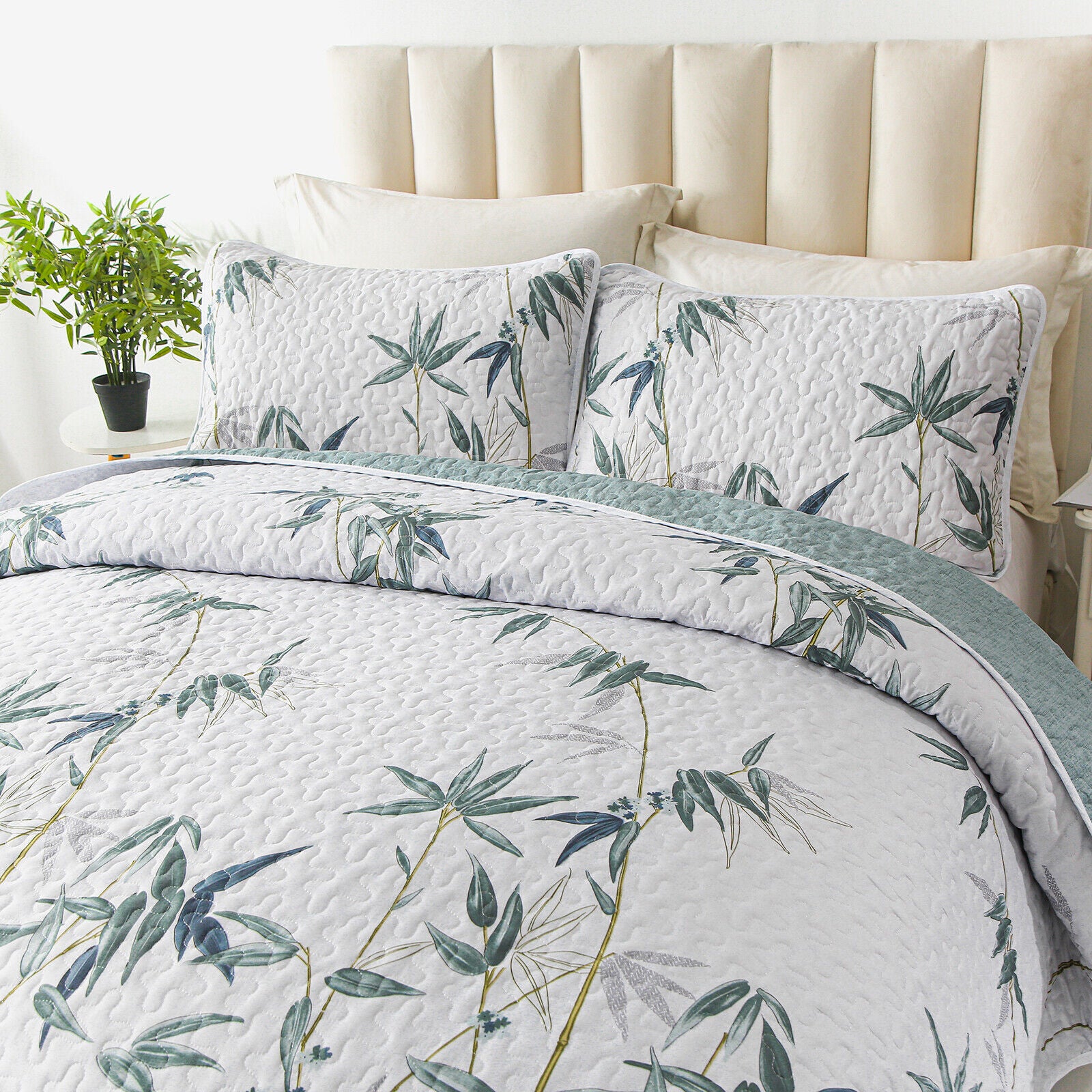 Soft leafey bloom Quilted 3 Pc Bedspread & Pillow Cover Set with botanical print on a neatly made bed in a bright bedroom