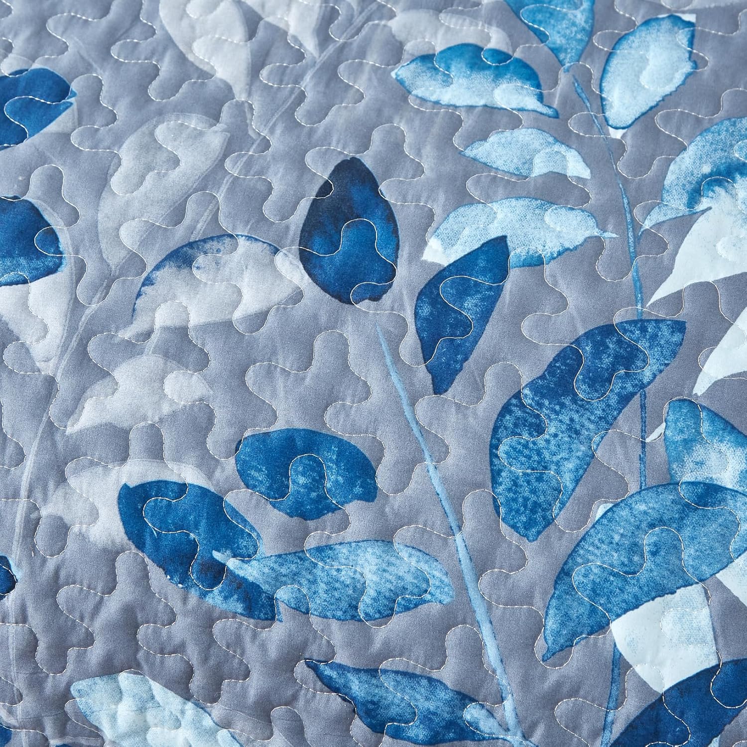 Close-up of blue floral pattern and quilting on the Tranquil Zen Garden Floral 3 Pc Bedspread & Pillow Cover Set