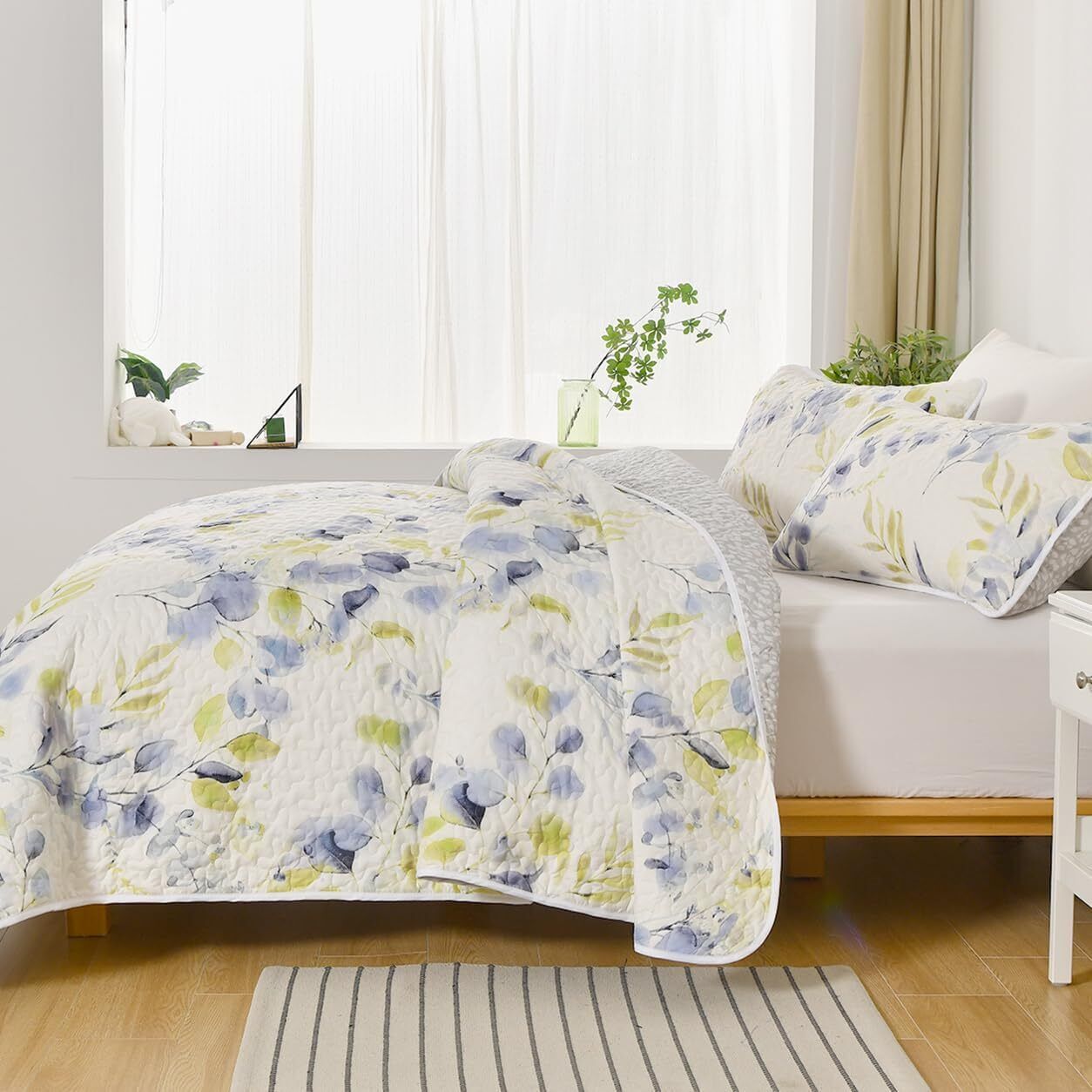 Regal Orchid Bloom 3 Pc Bedspread & Pillow Cover Set with floral quilt design on a wooden bed in bright bedroom