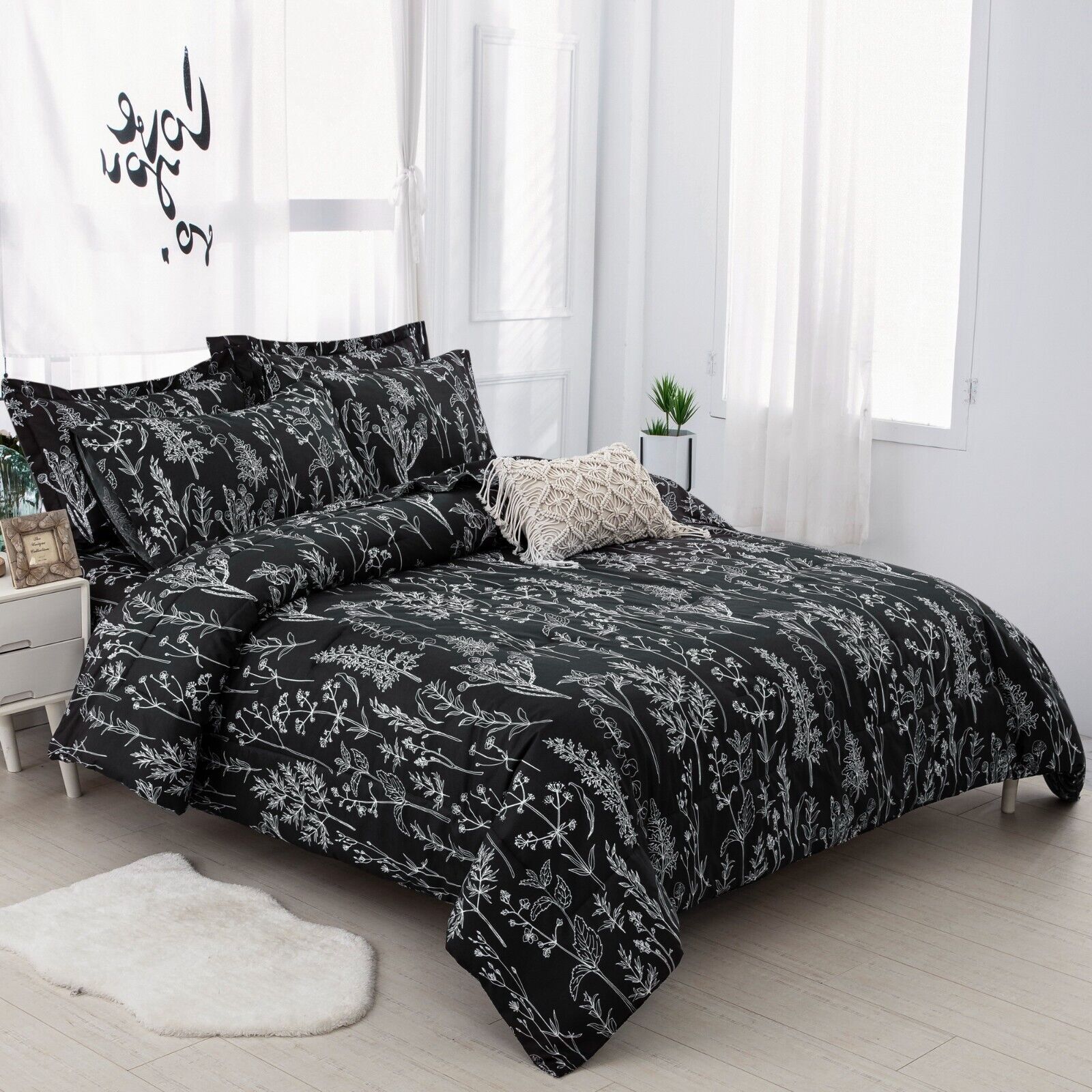 Floral Leaves Comforter Set, Queen Size, Microfiber Quilted Bedding with Pillowcase in black with white botanical pattern on bed in bright room