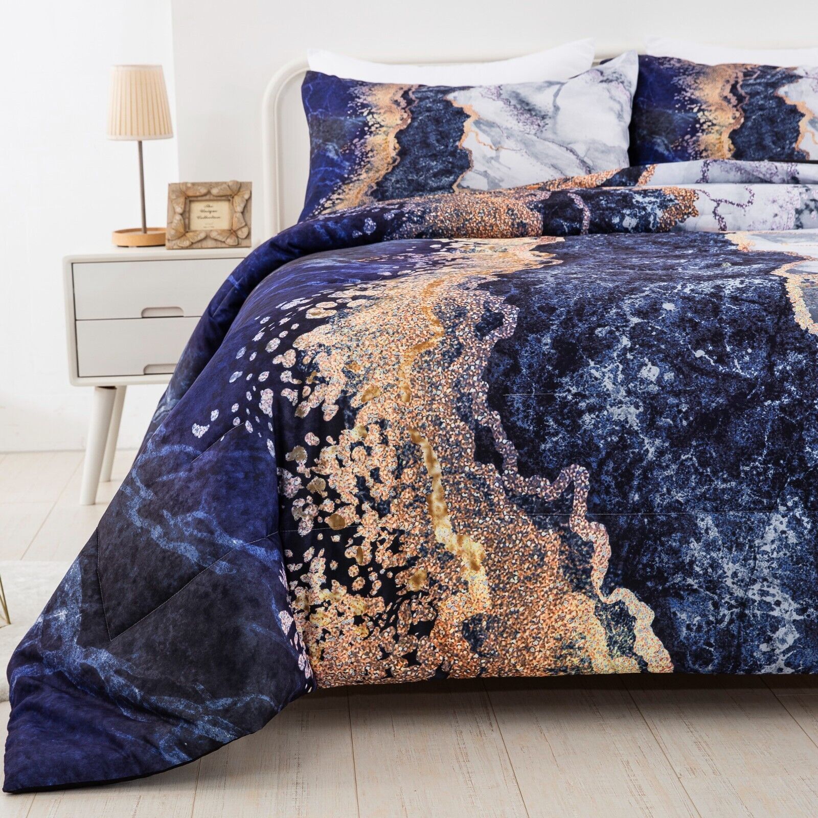Blue Marble Comforter Set, King Size, Retro Watercolor 3-Piece Bedding Ensemble on bed with white frame and nightstand