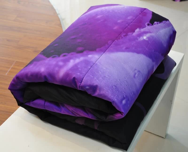 Rose Golden Hour Comforter Set – Aesthetic 3‑Piece Bedroom Mood folded bedding with purple and black color scheme on white surface