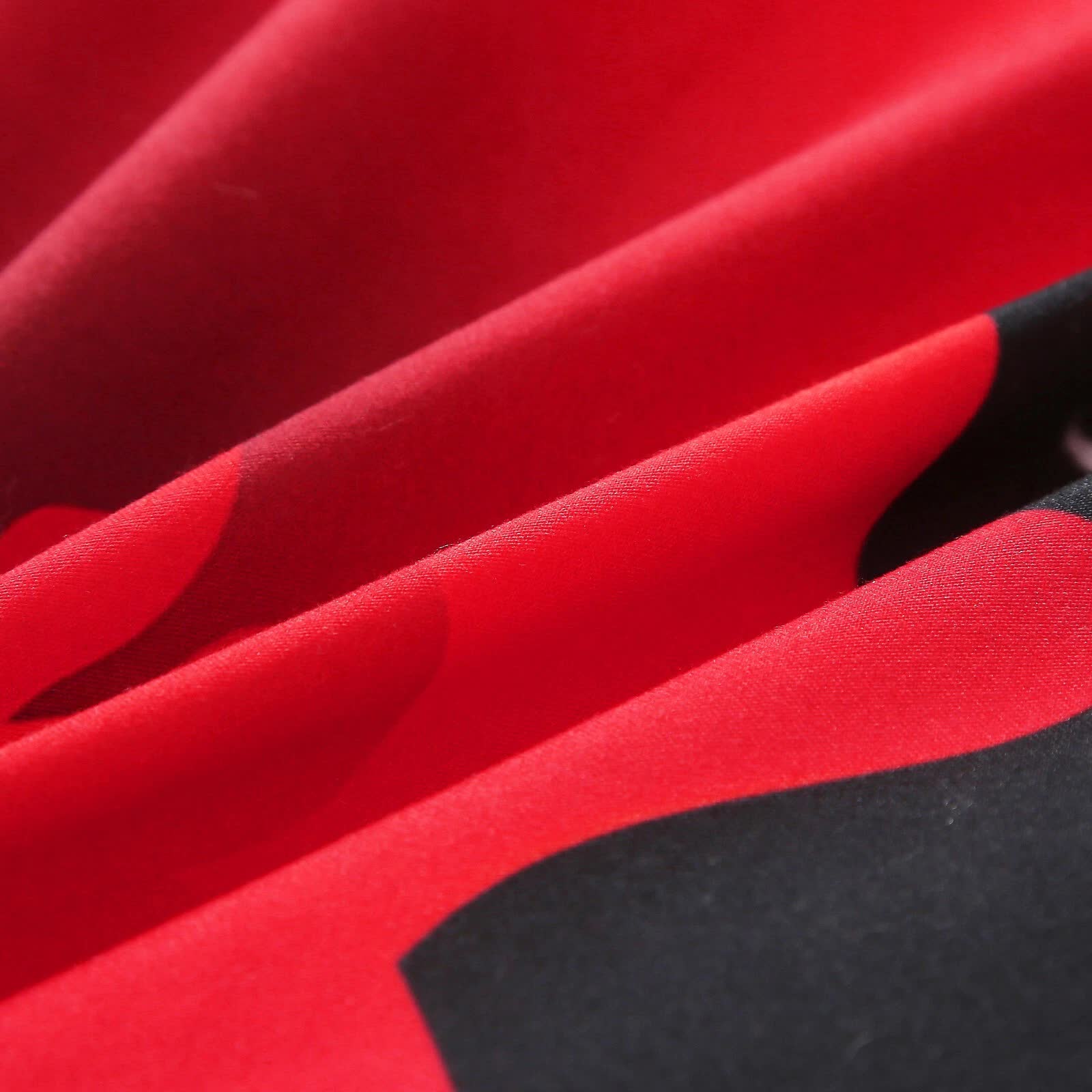 Close-up of red and black fabric texture from Chill Haven Red Rose 3‑Piece Comforter Bundle – Relax & Recharge Style by Bedzy