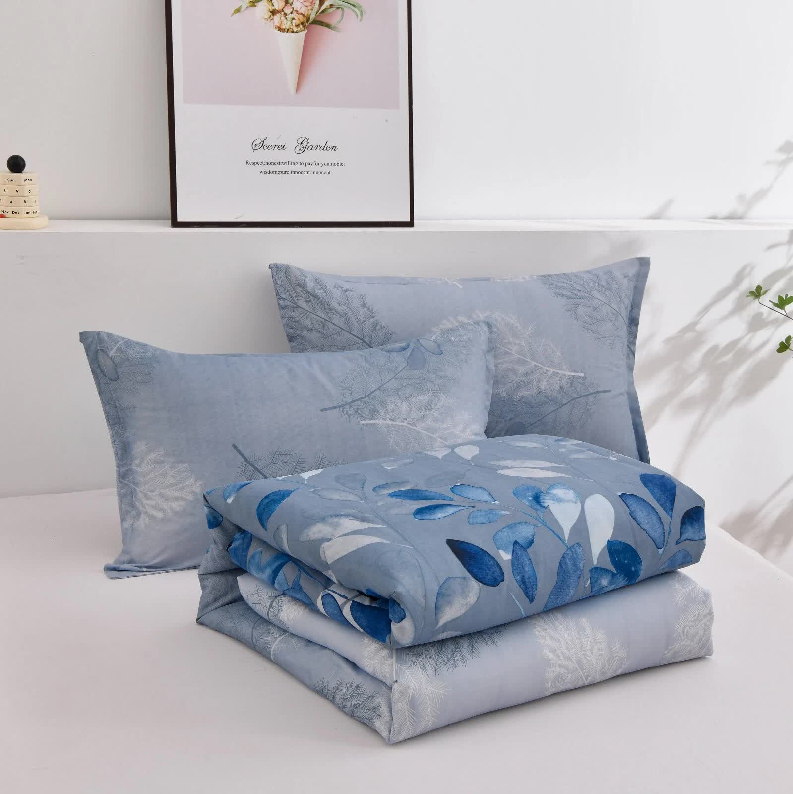 GlowUp Bedroom Comforter – 3‑Piece Insta‑Aesthetic Set in blue tones with leaf pattern, pillows and folded comforter on bed