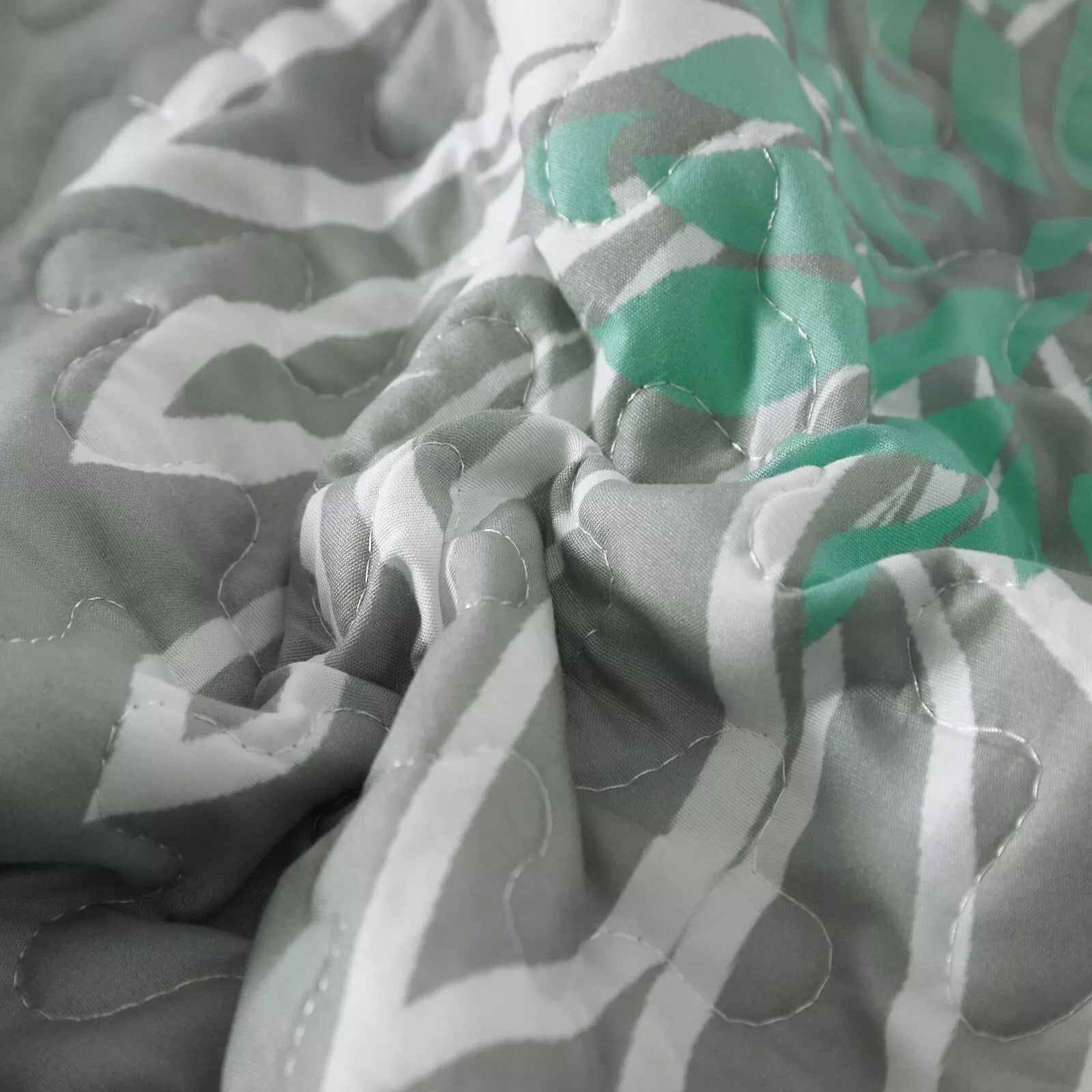 Close-up of the Elegant Quilted Bedspread and Pillowcases Set: Infuse Your Bedroom with Charm - Queen size showcasing quilted pattern and fabric texture.
