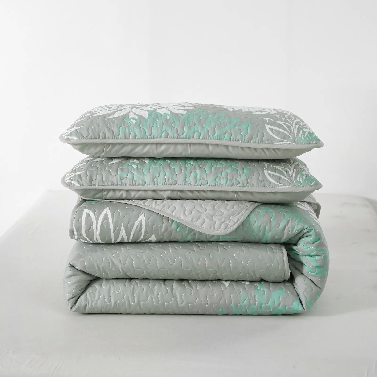Elegant Quilted Bedspread and Pillowcases Set: Infuse Your Bedroom with Charm - Queen size folded gray and mint bedding set with floral pattern
