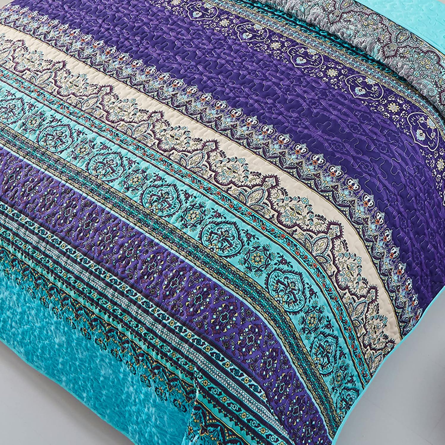 Close-up of the Tranquil Quilted coverlet and pillowcovers set: Perfect for Relaxation - Queen size with intricate blue and purple patterns