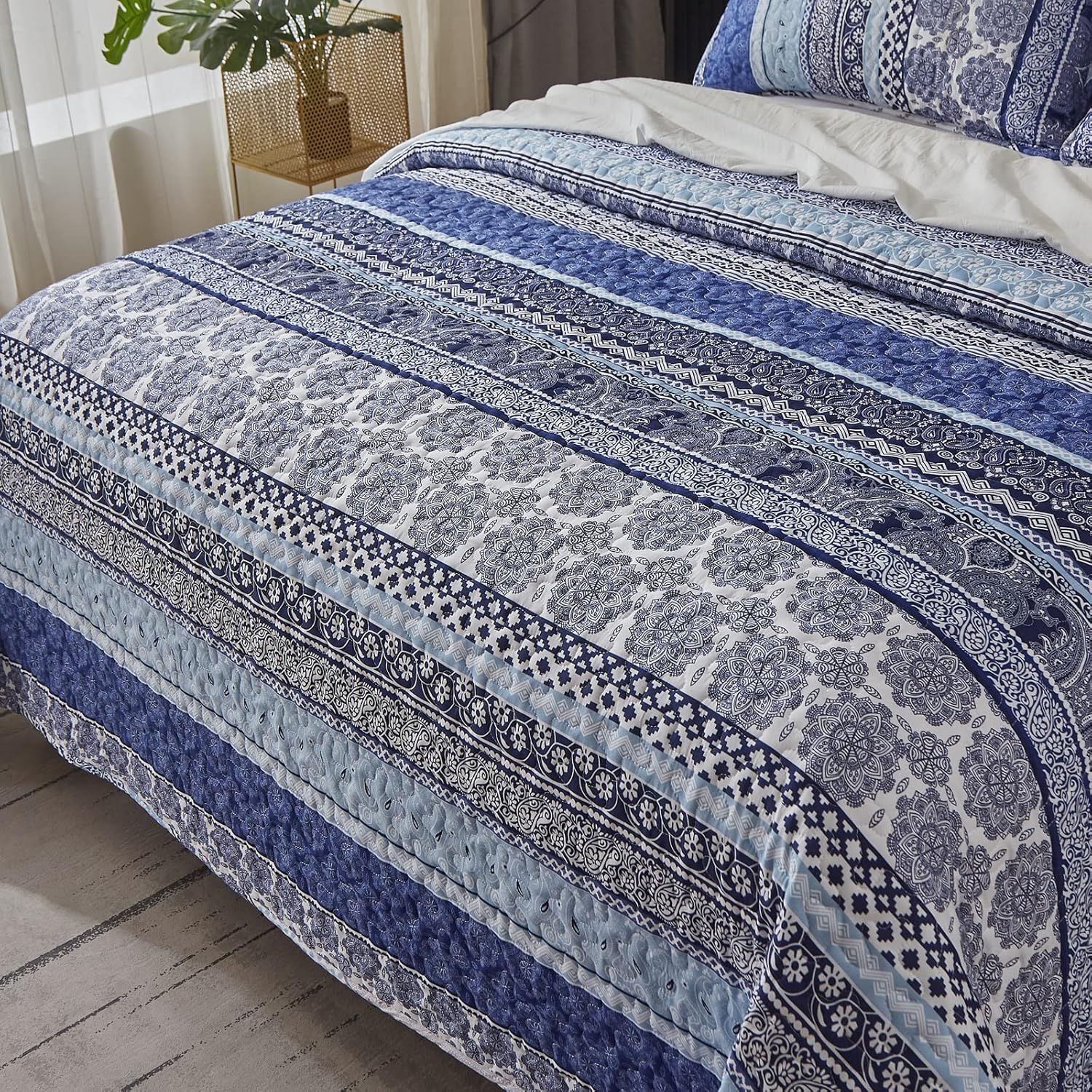 Sophisticated Quilted Coverlet and Pillowcases Set: A Timeless Addition - Queen size with blue patterned quilt on bed in bedroom setting