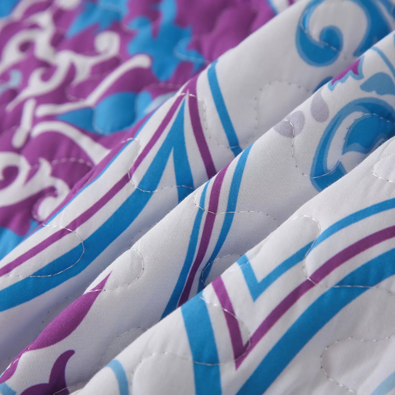 Close-up of Handsome Quilted Bedspread and Pillowcases Set: Strong, Sturdy, and Stylish - Queen size with blue and purple pattern detailing