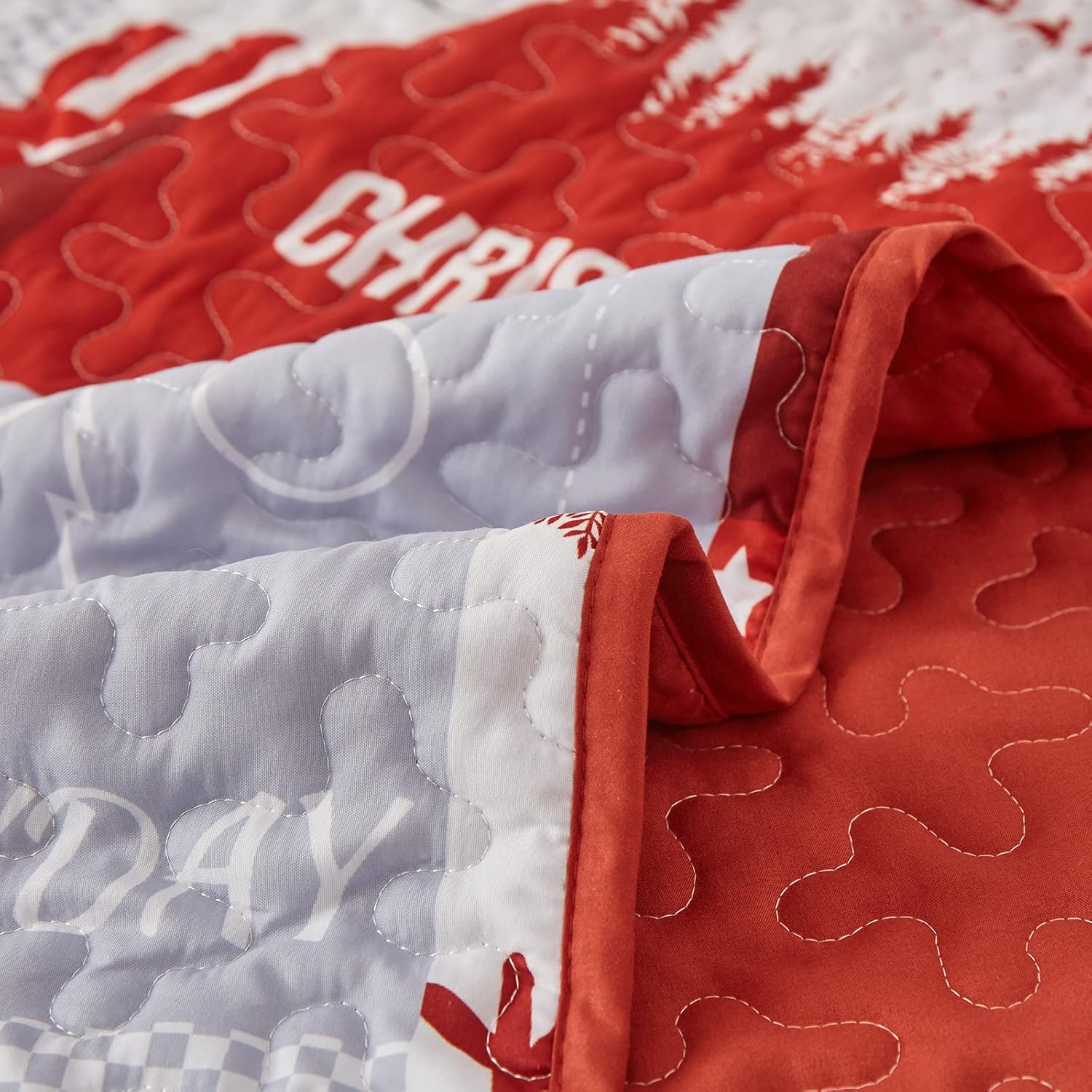 Close-up of Winter Wonderland snowman santa Christmas Queen Bedspread Set with red and white quilted fabric and festive stitching