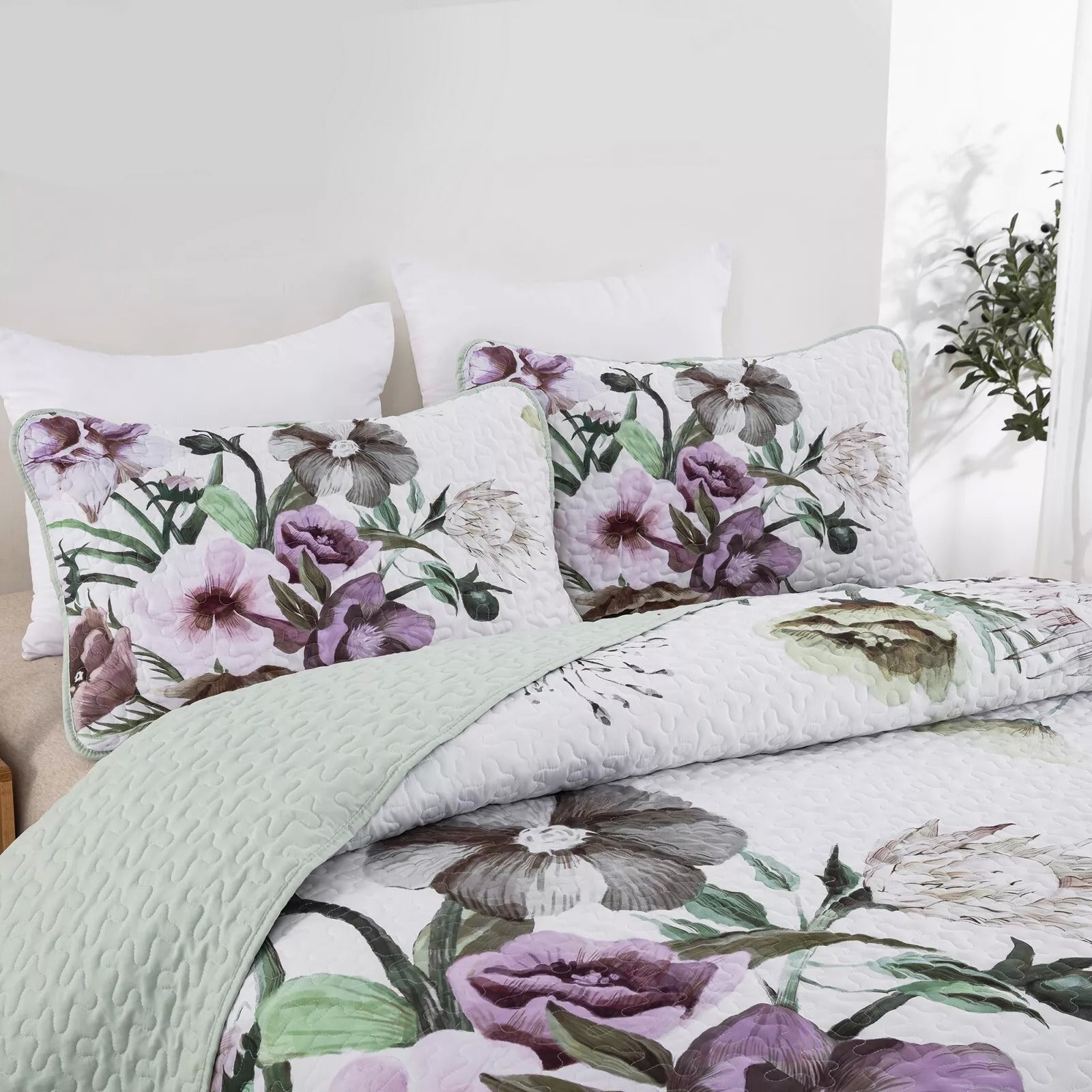 Deluxe Quilted Bedspread and Pillowcases Set: Infuse Your Bedroom with Style - Queen size with floral pattern and quilted texture displayed on bed.