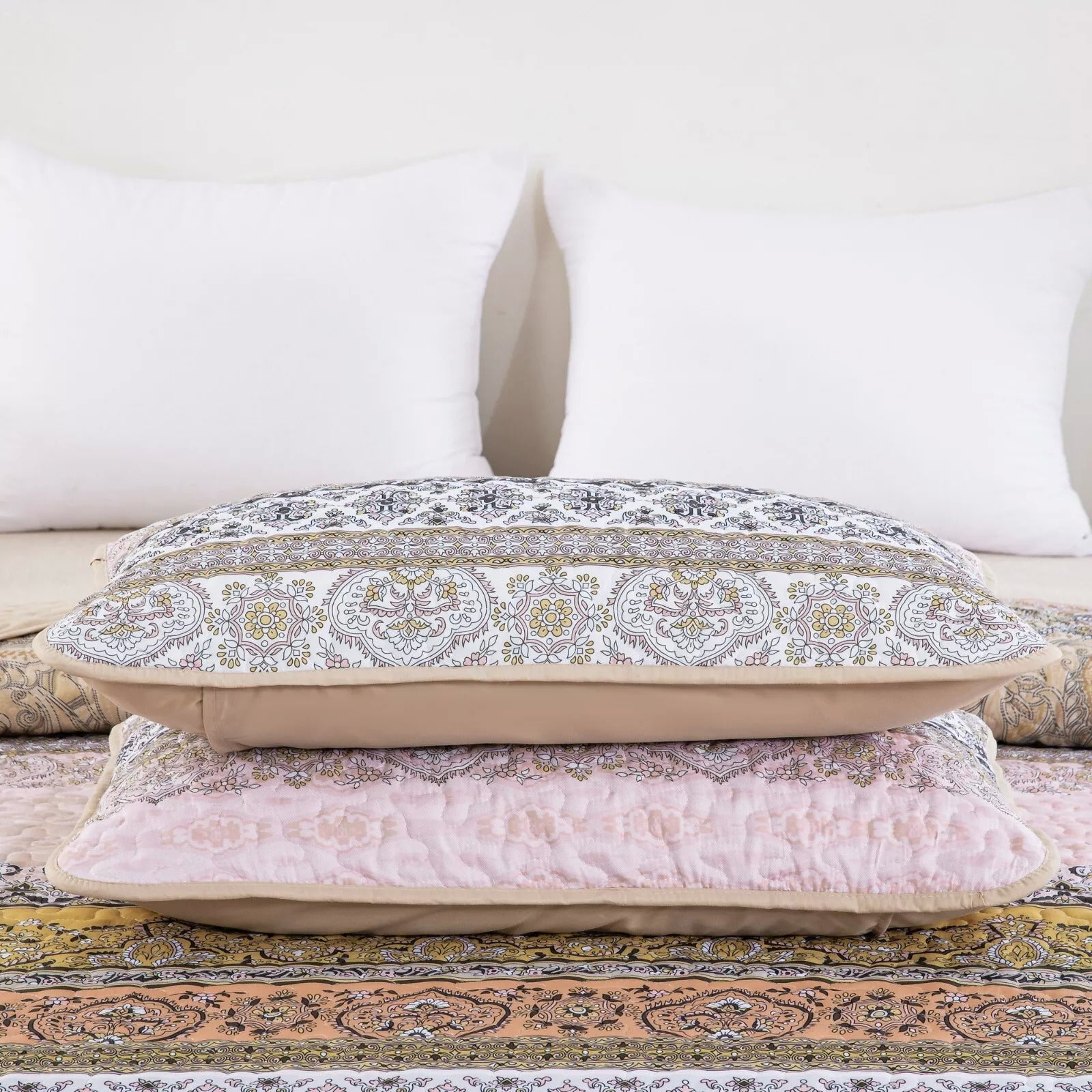 Crafted Quilted Bedspread and Pillowcases Set: A Testament to Skilled Craftsmanship - Queen size with patterned pillows on bedzy bed