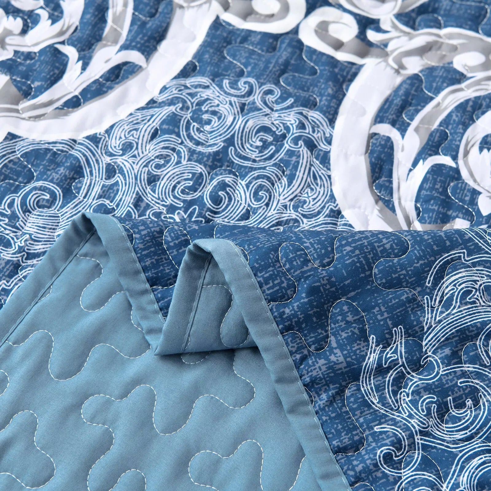Close-up of blue and white intricate design showing quilting detail of Alluring Quilted bedspread and pillowcovers set: Luxurious Bedroom Addition - Queen size