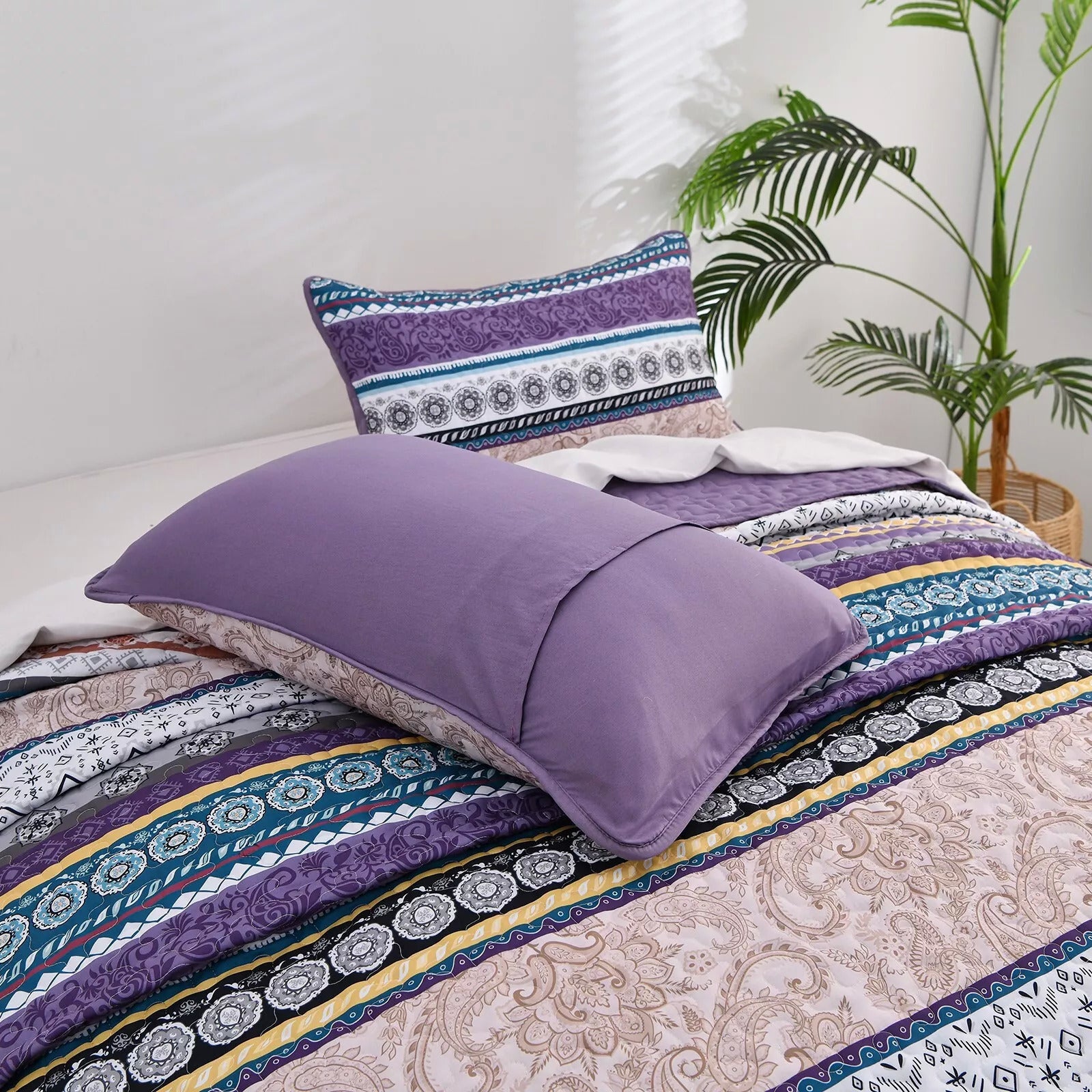 Hygge Quilted bedspread and pillowcovers set: Embrace Cozy Living - Queen size with patterned stripes and solid purple pillowcases displayed on bed