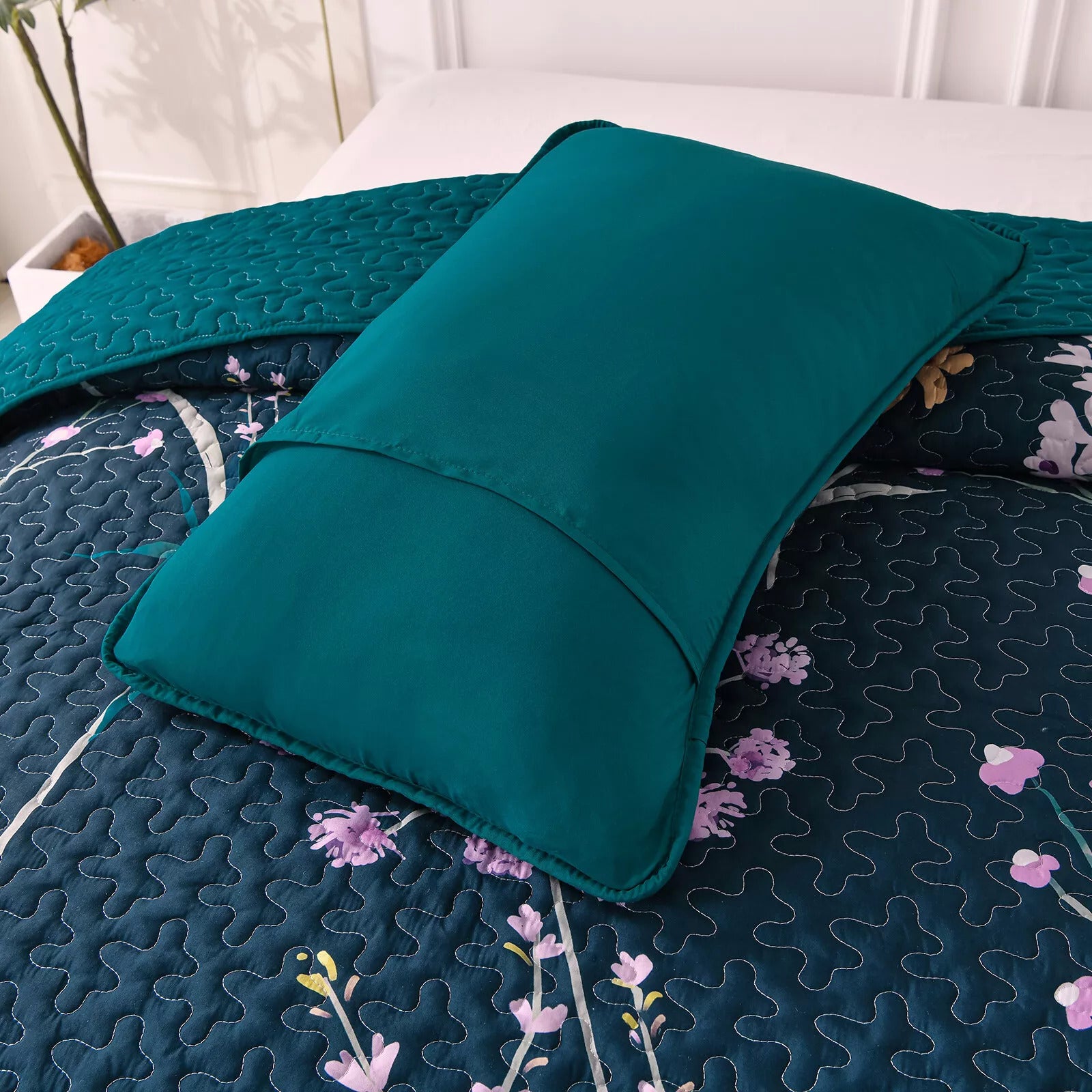 Abstract Quilted coverlet and pillowcovers set: Unique and Artistic - Queen size with floral quilt and solid teal pillow on bed