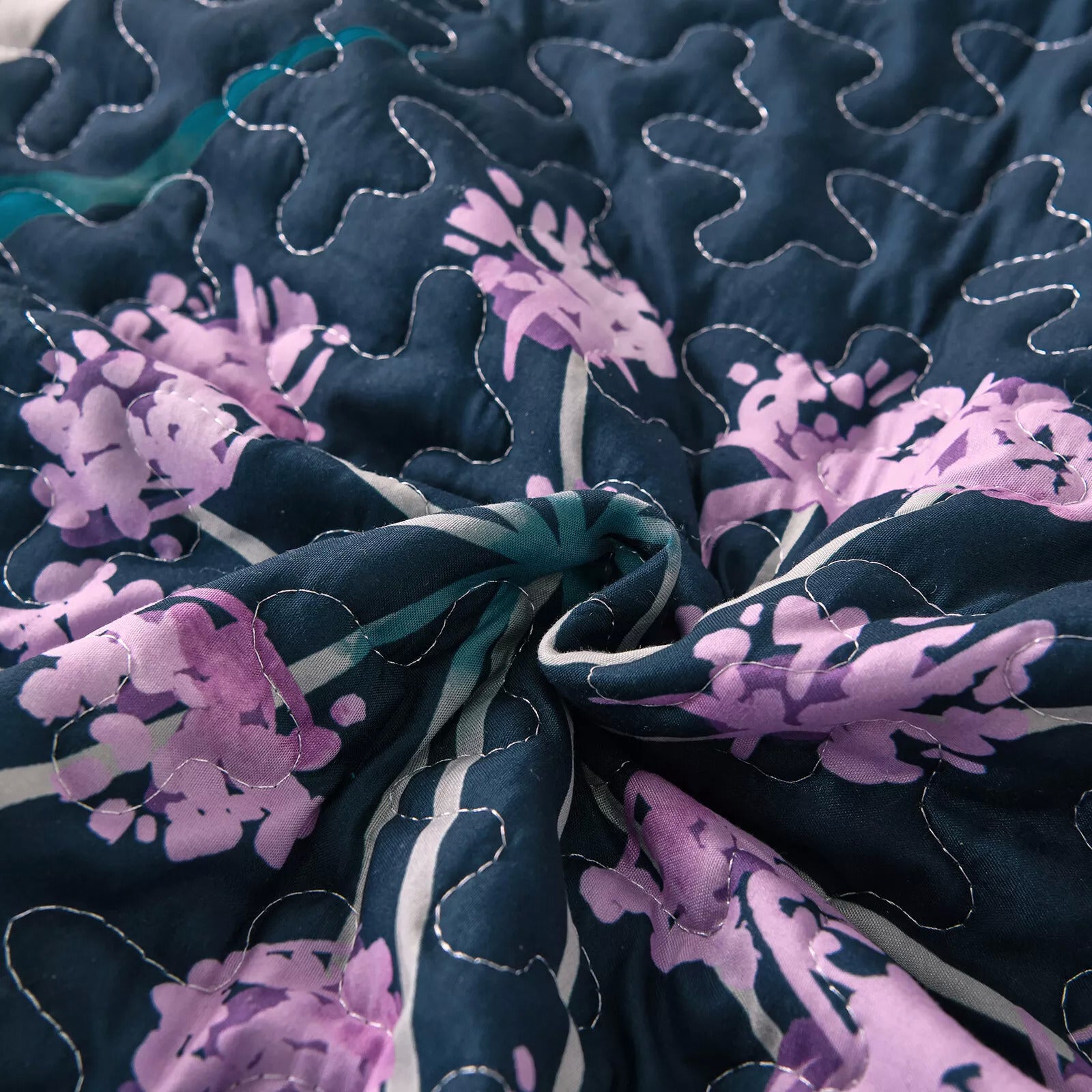 Close-up of Abstract Quilted coverlet and pillowcovers set: Unique and Artistic - Queen size with purple floral pattern and stitching detail